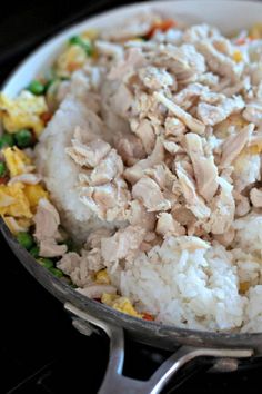 rice, peas and chicken in a pan on the stove