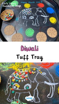 an elephant drawn on top of a black tray with colorful paint and cookies next to it