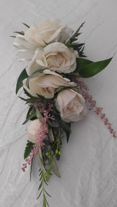 a bouquet of flowers laying on top of a white sheet