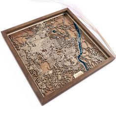 an intricate wooden map is displayed on a white surface