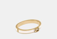 Plated brass and enamel Hinged closure Diameter: 2 1/4 x 2 Style No. F67480 Felt Pouch, Brass Hinges, Coach Outlet, Zip Wallet, Hinged Bangle, Jewelry Cleaner, Belt Size, Signature Style, Womens Bracelets