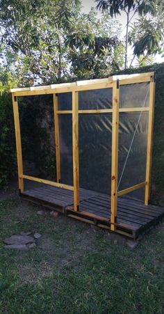 a small wooden structure sitting in the grass