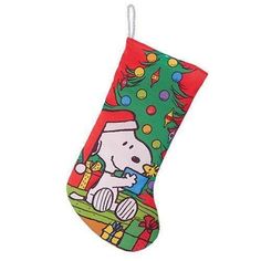 a snoopy christmas stocking hanging from the ceiling with a tree and presents on it