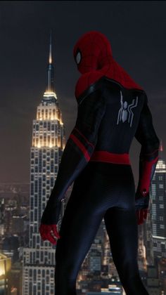 the spider - man is standing in front of a cityscape