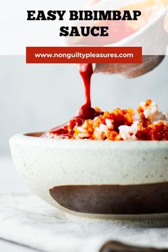 a person pouring sauce into a bowl filled with food