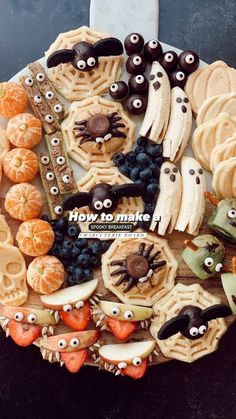 a plate filled with halloween themed cookies and candies on top of a black table