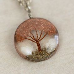 What a truly special piece the Sephira Life Tree Pendant Necklace is! A beautiful, blooming tree of life design is embedded into clear resin, which hangs as a pendant from a silver-toned chain. Makes a perfect gift for a beloved grandparent or family member, symbolizing ancestral roots. Lovingly handcrafted by artisans with Intercrafts Peru, a cooperative with more than 700 makers who come together to strengthen communities by providing access to health care, loans, advances, and training while