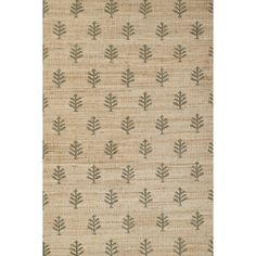 a beige rug with green leaves on it