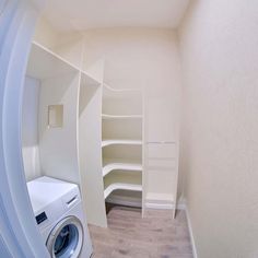 a washer and dryer are in the corner of a room with white walls