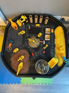 a black tray with construction toys on top of it and other items in the tray