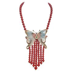 Indulge in the enchanting allure of this 14-karat yellow gold coral necklace, a masterpiece that promises to captivate and charm. At the heart of this exquisite piece lies a striking butterfly centerpiece, artfully crafted from tourmaline. Its wings shimmer with a vibrant array of gemstones—brilliant diamonds, vivid sapphires, lush emeralds, rubies, and a solitary aquamarine—each adding a touch of luxury and vibrant color. This necklace is not only a celebration of natural beauty but also a show Formal Necklace With Butterfly Charm Pendant, Formal Butterfly Charm Pendant Necklace, Luxury Formal Necklace With Butterfly Charm, Formal Pendant Necklace With Butterfly Charm, Formal Fine Jewelry Necklaces With Butterfly Charm, Luxury Butterfly Pendant Necklace For Formal Events, Elegant Butterfly Gemstone Necklace, Elegant Gemstone Butterfly Necklace, Red Butterfly Charm Necklace