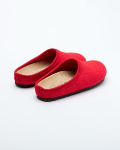 Description: The Nebraska Women's Wool Clog is an Italian take on a European classic. The women's Nebraska in red is one of the most versatile mule style slippers available. From home to the office to weekend, the minimalist design of these clogs will take you anywhere in comfort. The anatomical self-molding latex and thermoforming cork insole provide a firm customized comfort, and the insole is completely removable. LeClare Slippers are exclusively handcrafted in our small-batch factory in Trev Solid Color Closed Toe Clogs With Cushioned Footbed, Closed Toe Clogs With Cushioned Footbed, Clogs With Rubber Sole And Round Toe, Solid Color Slip-on Clogs With Rubber Sole, Comfortable Red Slippers With Rubber Sole, Indoor Closed Toe Clogs With Cushioned Footbed, Red Round Toe Slippers For Indoor Use, Red Slip-on Slippers With Rubber Sole, Red Slip-on Slippers With Leather Sole