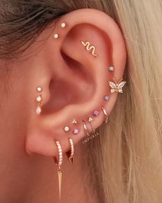 a woman wearing three different ear piercings