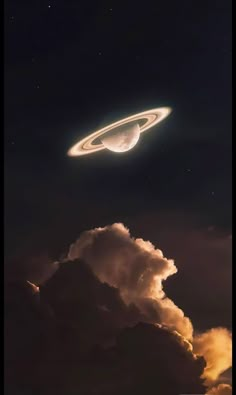 an object is flying in the sky above some clouds and dark night skies with stars