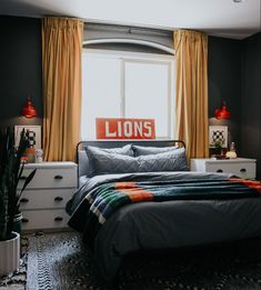 a bedroom with black walls and yellow curtains