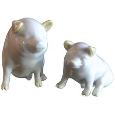 two white ceramic animals sitting next to each other