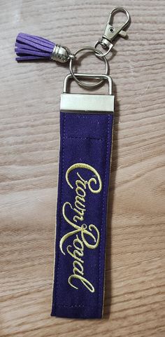 a keychain with the word congratulations on it and a tassel hanging from it