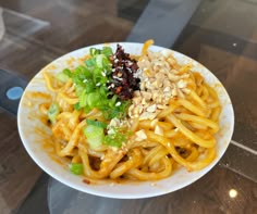 a white plate topped with noodles and vegetables