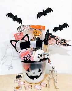 a halloween gift basket with lots of goodies in it and bats on the wall