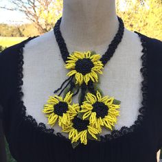 Black Eyed Susan Flower Choker.  Freya's Sacred Flower Statement Necklace is Layered & Long and Handcrafted in Eco-Friendly Glass Seed Beads. *A  Choker Necklace with a Central large flower with three overlapping dangling  flowers creating a striking  and Dramatic Necklace. *The Base is a band of Braided Black Seed beads laying flat and Smooth; very Comfortable. * The Choker is 17 Inches around and adjustable to 19 inches around using one of the three balls for closure. *Each necklace comes Elegantly Gift Boxed with Enclosure Cards. *See more of my work at www.kimerixon.com Dangling Flowers, Black Eyed Susan Flower, Sacred Flower, Dramatic Necklace, Eco Friendly Necklace, Floral Choker, Beadwork Ideas, Flower Statement Necklace, Flower Choker