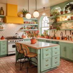 a kitchen filled with lots of green cabinets and counter top next to a stove top oven