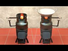 two large black pots sitting next to each other on top of a red tile floor