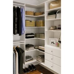 an organized closet with white shelves and drawers