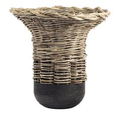 a vase made out of wicker and black stone is shown on a white background