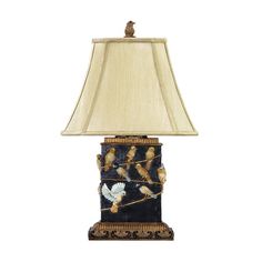 a lamp that has birds on it with a beige shade over the base and bottom