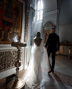 the bride and groom are walking towards the alter