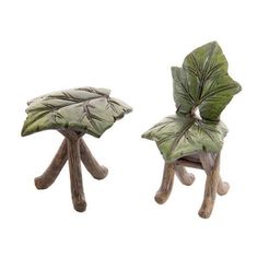 two small wooden stools with green leaves on them