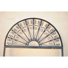 an iron arch over a white wall