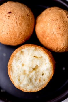 three muffins sitting on top of a black plate