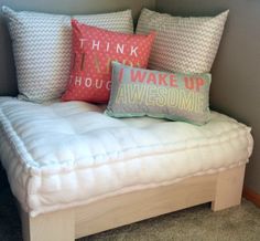 a white couch with pillows on top of it and the words think i have to wake up awesome