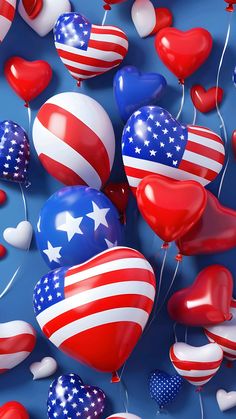 many heart shaped balloons with the american flag on them are floating in the air together