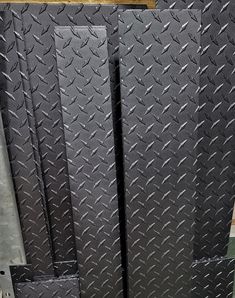 several black diamond plated steel doors in a warehouse