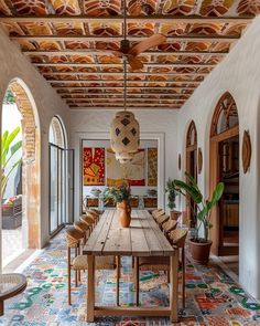 the dining room is decorated with colorful tiles and wooden tables, along with potted plants