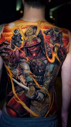 the back of a man's body with tattoos on it, including an image of samurai