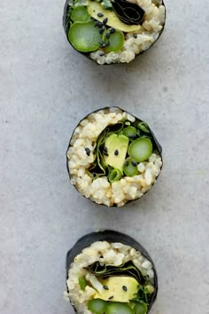 three sushi rolls with cucumbers and other vegetables