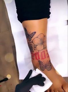 a woman's foot with butterflies and the word hope tattooed on her left leg