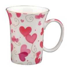 a pink and white cup with hearts on it