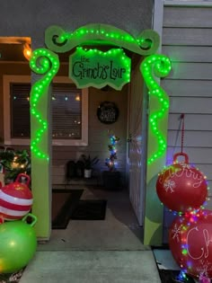 an entrance to a house decorated with christmas decorations and lights for the holiday season,