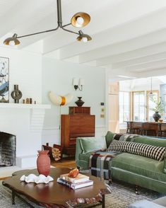 a living room filled with furniture and a fire place