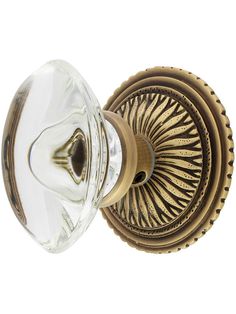 an antique brass door knob with a clear glass cover on the front and side of it