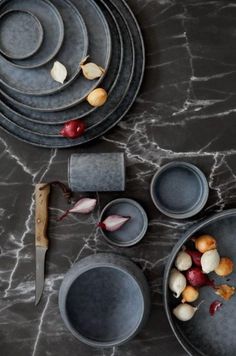 the table is set with plates, bowls and utensils