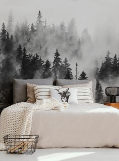 a bedroom with a deer head on the wall and fog in the trees behind it