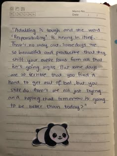 an open notebook with writing on it and a panda bear sticker in the middle