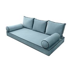 a blue couch with pillows on it and a rolled up pillow in the middle is shown