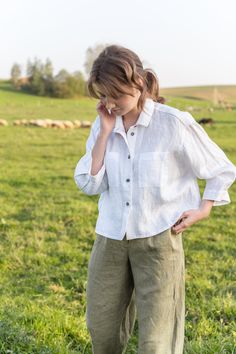 "An Oversized Linen Shirt is for sure a wardrobe staple for all times. Classic modest style is moderately embellished with stylish patch pockets. This white button up shirt can be favorably combined both with loose and classic bottoms. A slightly cropped design delicately hints at the waistline. Thus, it creates a perfect balance to a current-day trend on oversized clothes. DETAILS ⚬ Spread collar. ⚬ Patch pockets are decorated with handmade fancy stitches. ⚬ Button fastening. ⚬ 3/4 sleeve. ⚬ Sl White Linen Shirt Outfit, Linen Shirt Outfit, Oversized Linen Shirt, Oversized Clothes, Modest Style, White Linen Shirt, Linen Blouse, Shirt Button, Cultura Pop