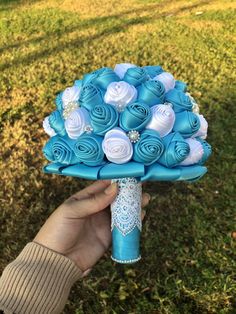 someone holding a blue and white bouquet in their hand